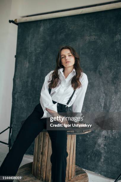 beautiful woman posing in studio - women in suspenders fotografías e imágenes de stock