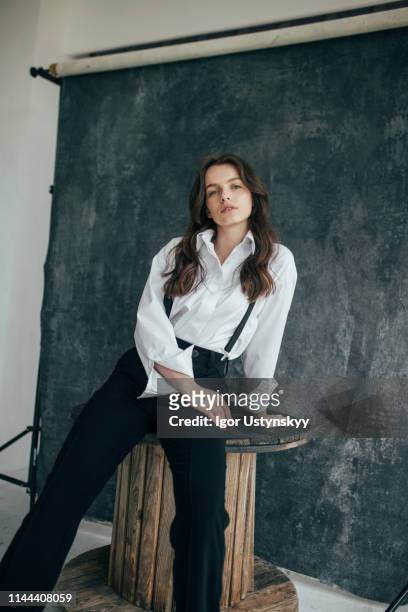 beautiful woman posing in studio - women in suspenders 個照片及圖片檔