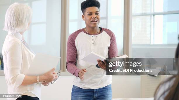 teenage boy gives presentation in front of class - boy in briefs stock pictures, royalty-free photos & images