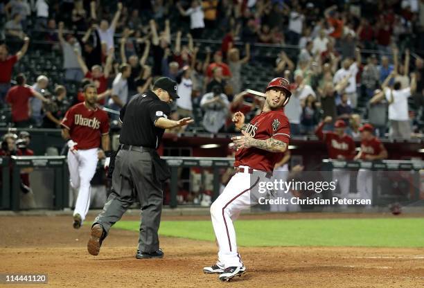 Ryan Roberts of the Arizona Diamondbacks celebrates after scoring the game winning run against the Atlanta Braves in the eleventh inning of the Major...