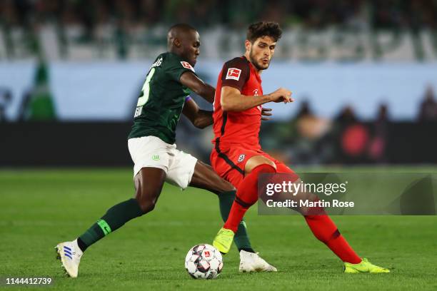 Goncalo Paciencia of Eintracht Frankfurt battles for the ball with Josuha Guilavogui of VfL Wolfsburg during the Bundesliga match between VfL...