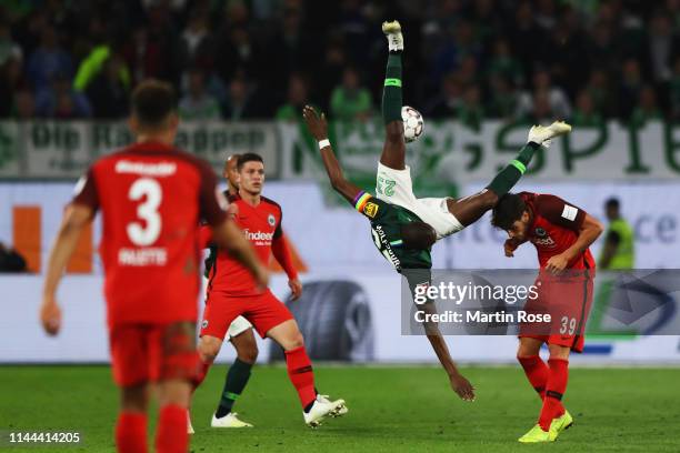 Josuha Guilavogui of VfL Wolfsburg falls over Goncalo Paciencia of Eintracht Frankfurt during the Bundesliga match between VfL Wolfsburg and...