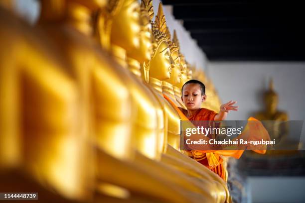 asian children novices are covering cloth, buddha are buddhist culture. - buddha face stock-fotos und bilder