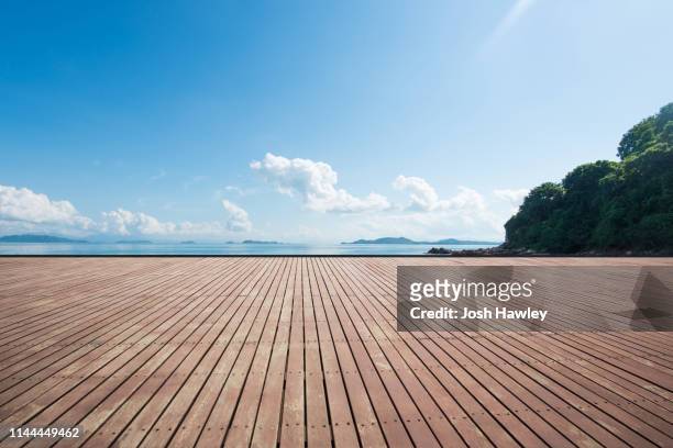 seaside wooden parking lot - blue wooden table stock-fotos und bilder