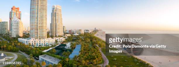 high drone panoramic view of south beach in miami from south pointe park, florida, usa - miami beach south pointe park foto e immagini stock