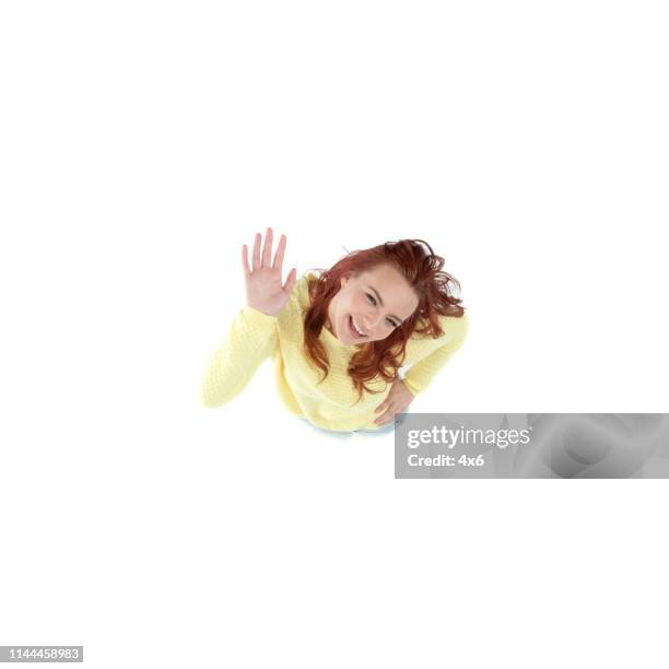 young female in yellow sweater looking up cheering - person look up from above stock pictures, royalty-free photos & images