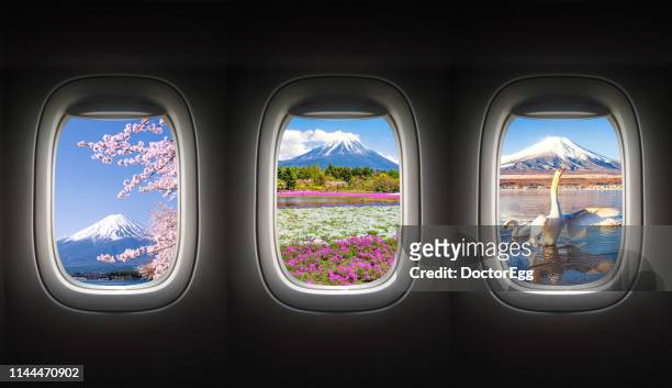 fuji mountain in different season from airplane window, japan - plane window stock pictures, royalty-free photos & images