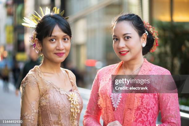 friends in traditional clothes smiling for the camera - インドネシア人 ストックフォトと画像