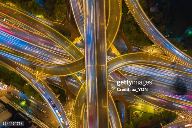 aerial top view of complicated multiple lane highway with traffic in day time - city of los angeles night stock pictures, royalty-free photos & images