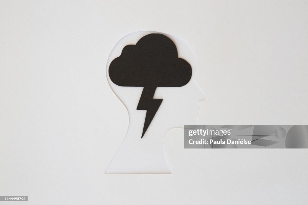 Paper human head with thunder cloud