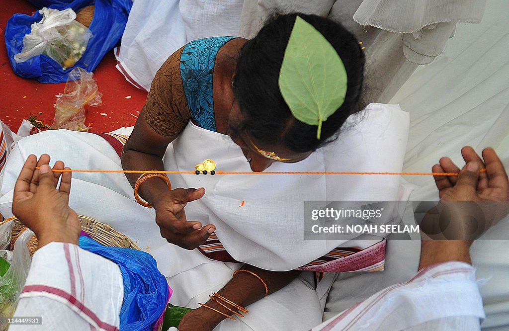 An Indian Hindu groom holds a 'mangala s