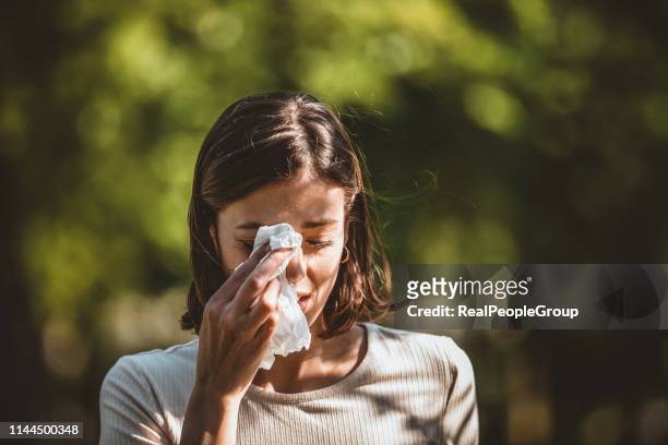 attractive woman outdoors is having allergy - allergy season stock pictures, royalty-free photos & images