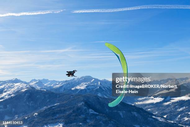 paraglider flies from the hohe salve into the valley of hopfgarten, tyrol, austria - hopfgarten stock pictures, royalty-free photos & images