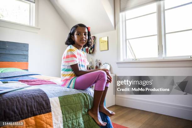 girl sitting alone in her bedroom - childrens bedroom stock pictures, royalty-free photos & images