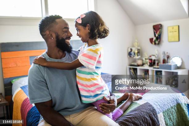 father and daughter laughing in bedroom - bare feet kneeling girl stock pictures, royalty-free photos & images