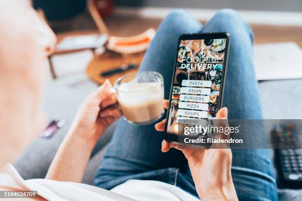 order food online - woman holding restaurant menu stock pictures, royalty-free photos & images