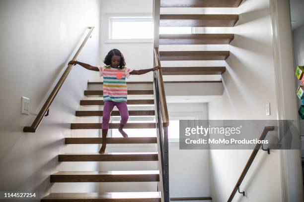 child running down staircase at home - kid looking down stock pictures, royalty-free photos & images