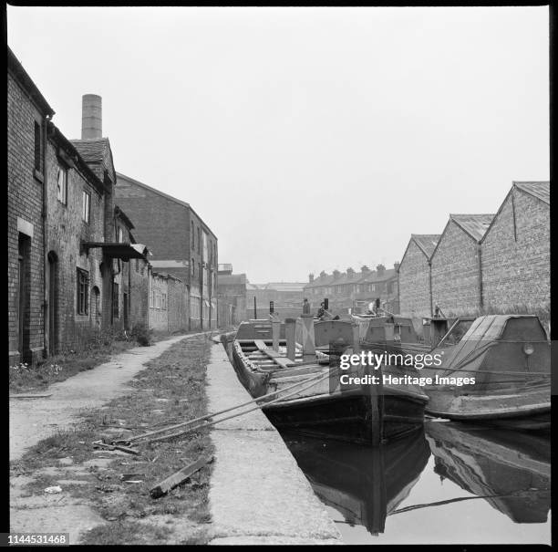 Barges on the Trent & Mersey Canal, Stoke-on-Trent, 1965-1968. Barges moored on the Trent & Mersey Canal opposite WJ Dolby's flint calcinating kiln....