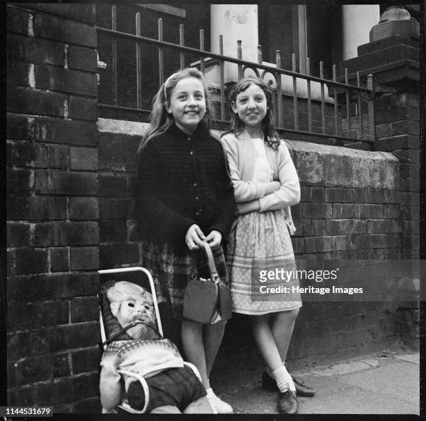 Two girls collecting 'pennies for the guy' outside Hill Top Methodist Church , Westport Road, Burslem, Stoke-on-Trent, 1965-1968. Artist Eileen Deste.