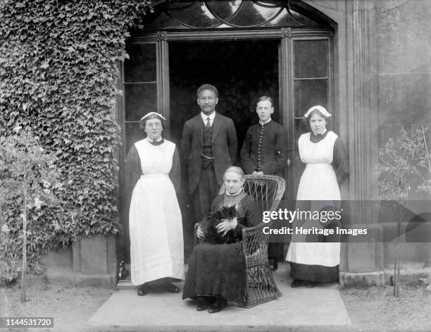 King's School House, College Green, Gloucester, Gloucestershire, 1860-1922. A group of domestic servants posed outside the doorway of King's School...