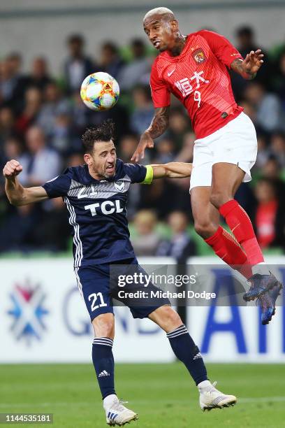 Anderson Talisca of Guangzhou Evergrande heads the Brisbane Lions over Carl Valeri of the Victory during the round 1 AFC Champions League Group F...