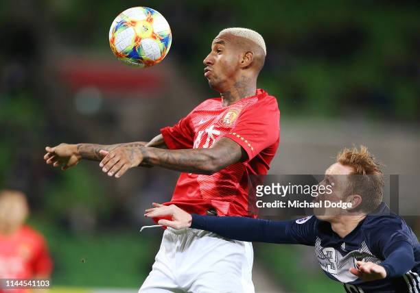 Anderson Talisca of Guangzhou Evergrande heads the ball from Corey Brown of the Victory during the round 1 AFC Champions League Group F match between...