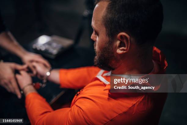 male prisoner sitting in interrogation room - prison visit stock pictures, royalty-free photos & images