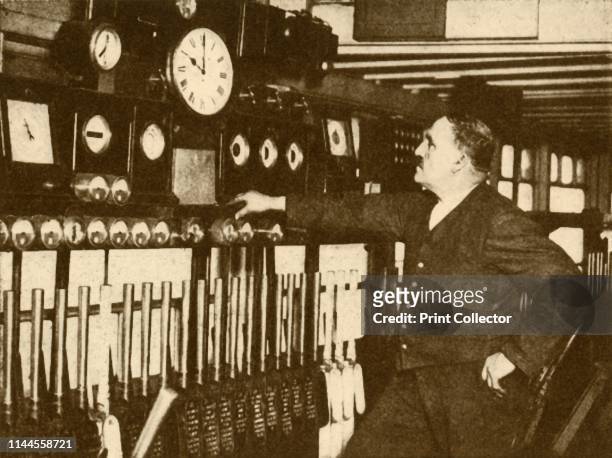 Recording Daily Time Signal at Liverpool Street Station, London and North Eastern Railway', 1930. From "The Wonder Book of Railways", edited by Harry...