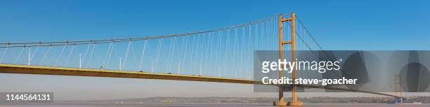 web banner style image of the humber bridge that joins hessle in yorkshire to barton in lincolnshire. - humber bridge stock pictures, royalty-free photos & images