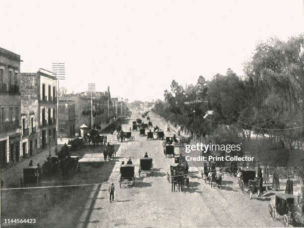 Avenida Juarez, Mexico City, Mexico, 1895. Carriages by the Alameda Central park. From "Round the World in Pictures and Photographs: From London...