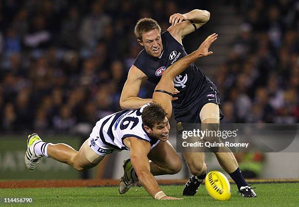 Tom Hawkins of the Cats and Jeremy Laidler of the Blues contest for the ball during the round nine AFL match between the Carlton Blues and the...
