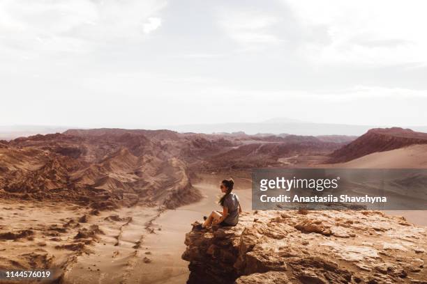 woman meets sunset at beautiful canyon in atacama desert - atacama stock pictures, royalty-free photos & images
