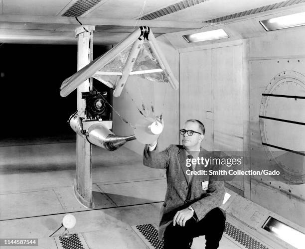 Sleeman, Jr inspecting a model of the "Rogallo Wing" paraglider in wind tunnel at Langley Research Center, Hampton, Virginia, February 5, 1962. Image...