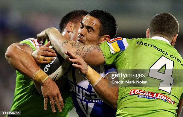 Dene Halatau of the Bulldogs is tackled during the round 11 NRL match between the Canberra Raiders and the Caterbury Bulldogs at Canberra Stadium on...