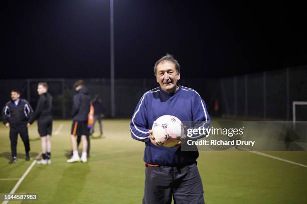 senior man holding soccer ball - football training stock-fotos und bilder