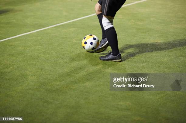 senior man playing soccer - soccer boot stock pictures, royalty-free photos & images