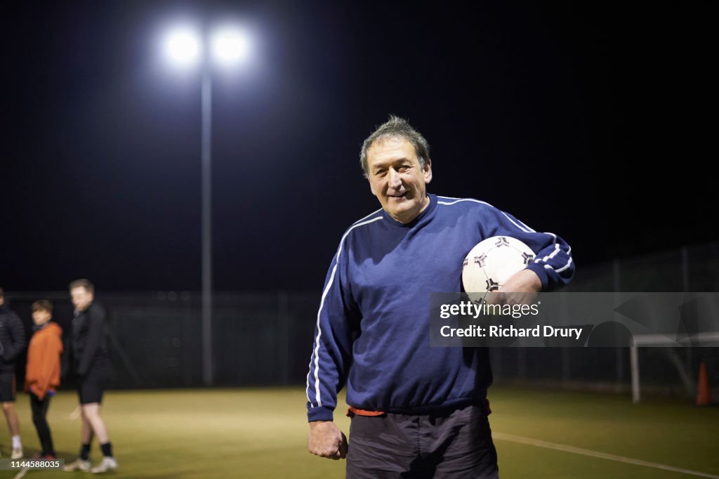 Senior man holding a soccer ball