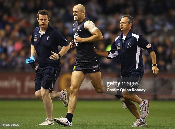 Chris Judd of the Blues comes off the ground with an injured foot during the round nine AFL match between the Carlton Blues and the Geelong Cats at...
