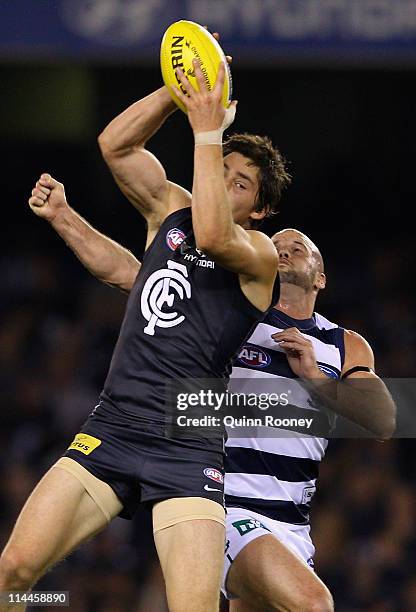 Nick Duigan of the Blues marks infront of Paul Chapman of the Cats during the round nine AFL match between the Carlton Blues and the Geelong Cats at...