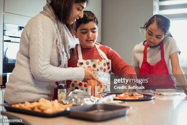 family bonding over dinner - cooking tasting stock pictures, royalty-free photos & images