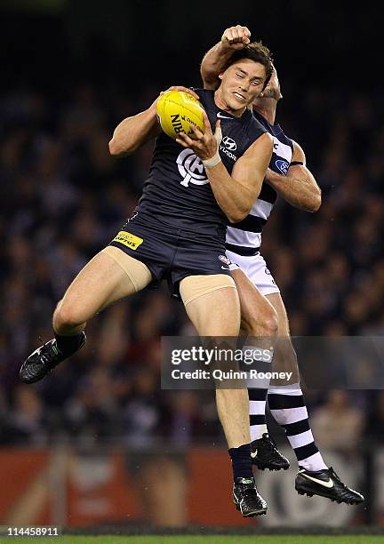 Nick Duigan of the Blues marks infront of Paul Chapman of the Cats during the round nine AFL match between the Carlton Blues and the Geelong Cats at...