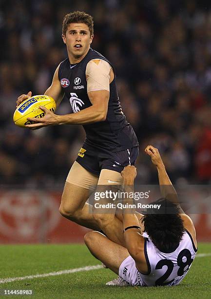 Marc Murphy of the Blues is tackled by Allen Christensen of the Cats during the round nine AFL match between the Carlton Blues and the Geelong Cats...