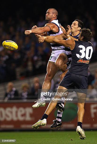 Josh Hunt of the Cats spoils a mark by Jarrad Waite of the Blues during the round nine AFL match between the Carlton Blues and the Geelong Cats at...