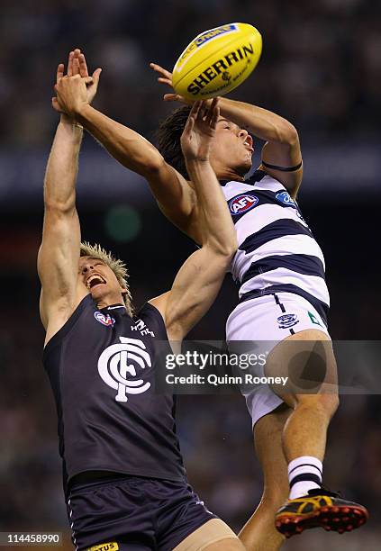 Allen Christensen of the Cats marks over the top of Denis Armfield of the Blues during the round nine AFL match between the Carlton Blues and the...