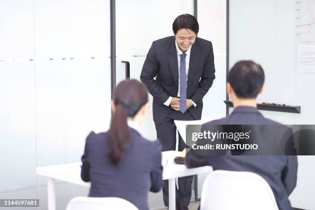 business people taking bow in meeting - お辞儀 ストックフォ�トと画像