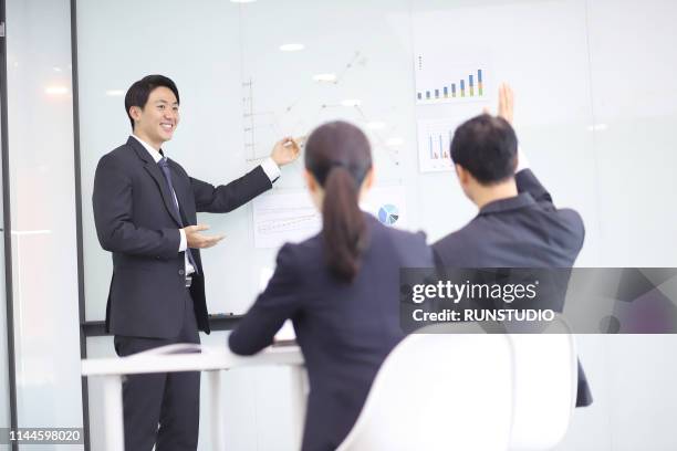 businessman explaining and pointing at chart on board - セミナー　日本人 ストックフォトと画像
