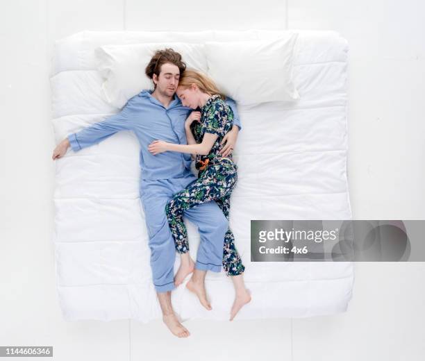 married couple sleeping in bed - bed on white stock pictures, royalty-free photos & images