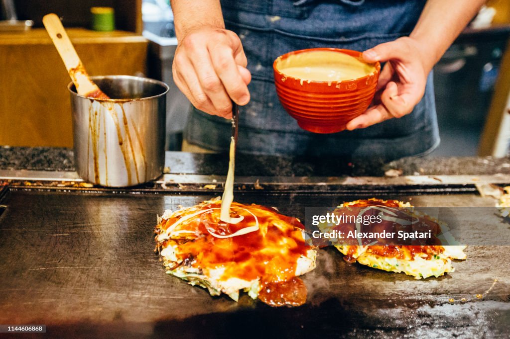Chef cooking okonomiyaki at Japanese restaurant