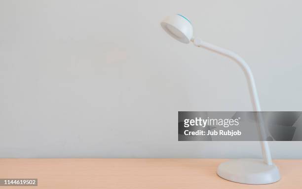electric lamp on desk against wall at office - angle poise lamp stock pictures, royalty-free photos & images