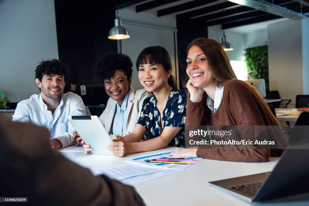 Smiling Business People Sitting In Office High-Res Stock Photo - Getty